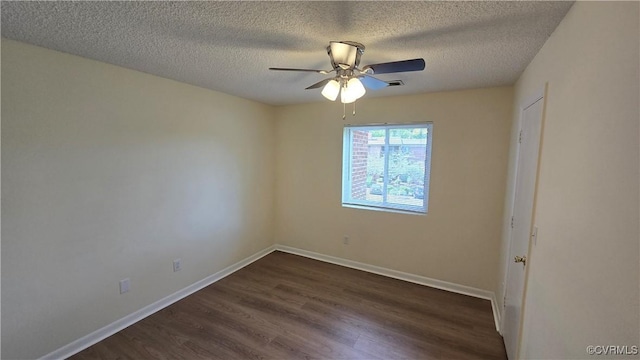 empty room with baseboards, a ceiling fan, dark wood-style floors, and a textured ceiling