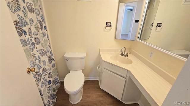 bathroom with vanity, toilet, baseboards, curtained shower, and wood finished floors