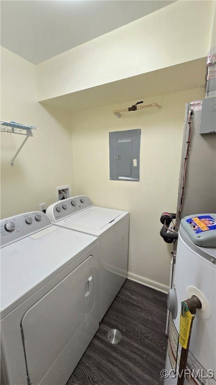 clothes washing area featuring laundry area, electric panel, independent washer and dryer, dark wood finished floors, and baseboards