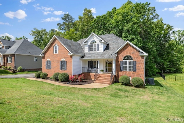 view of front facade featuring brick siding, covered porch, central air condition unit, and a shingled roof