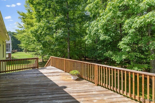 wooden deck featuring a yard