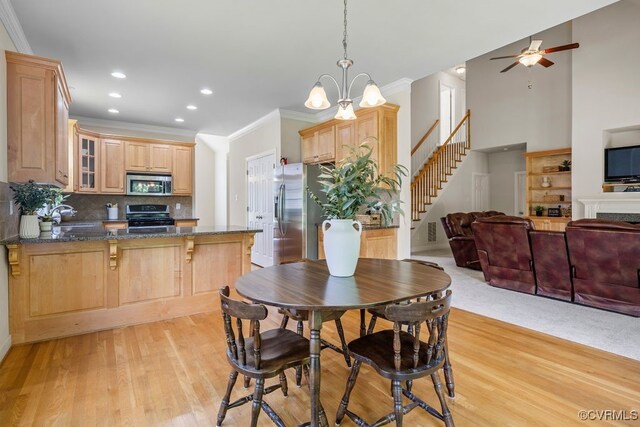 dining area featuring ornamental molding, stairway, light wood-style flooring, recessed lighting, and ceiling fan