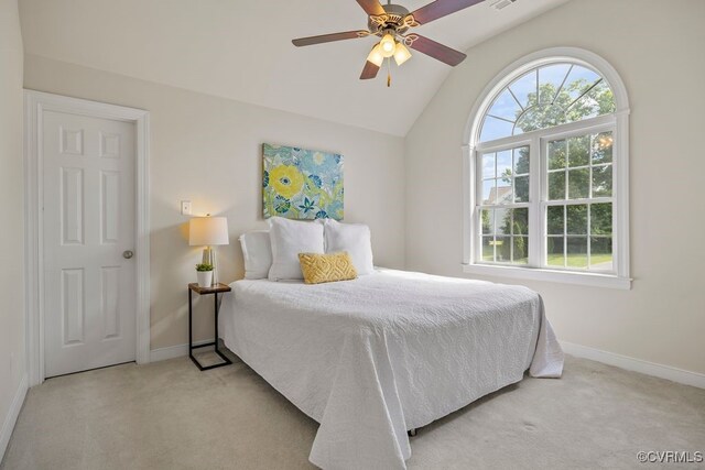 carpeted bedroom featuring baseboards, lofted ceiling, and a ceiling fan