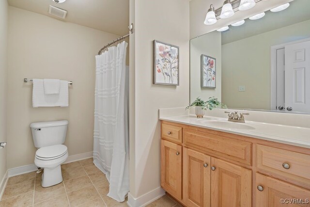 bathroom with baseboards, toilet, tile patterned floors, and vanity