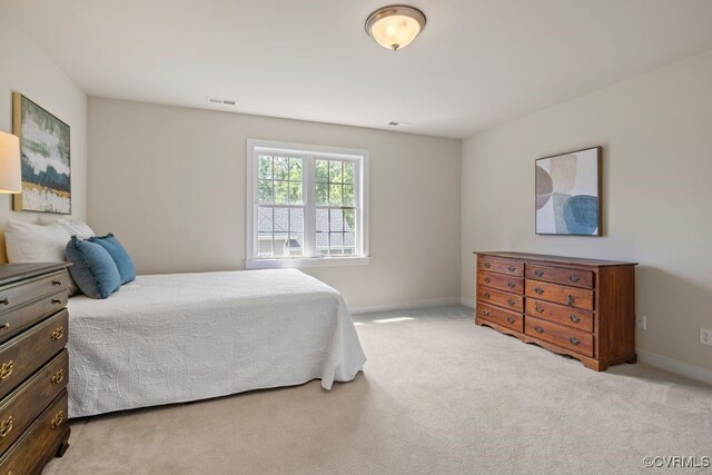 carpeted bedroom featuring baseboards