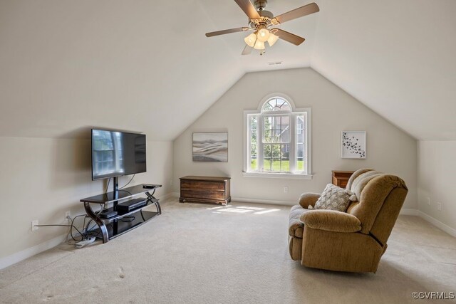 sitting room featuring carpet, vaulted ceiling, baseboards, and a ceiling fan