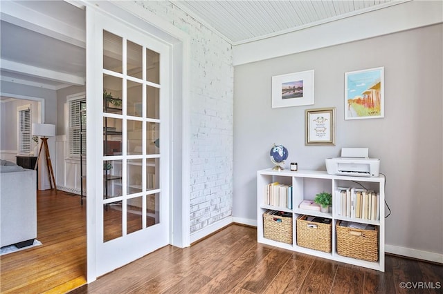 interior space with baseboards and wood finished floors