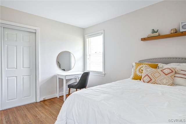 bedroom featuring baseboards and wood finished floors