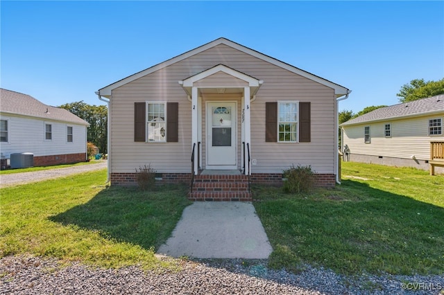 bungalow with crawl space, central AC, and a front yard