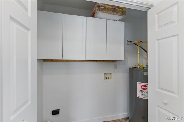 washroom with hookup for a washing machine, cabinet space, and electric water heater