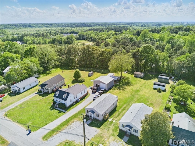 aerial view featuring a residential view and a wooded view
