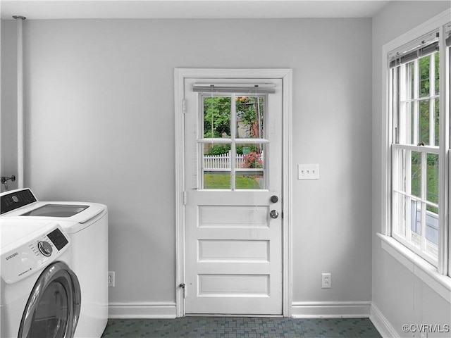laundry room with baseboards, plenty of natural light, laundry area, and washer and dryer