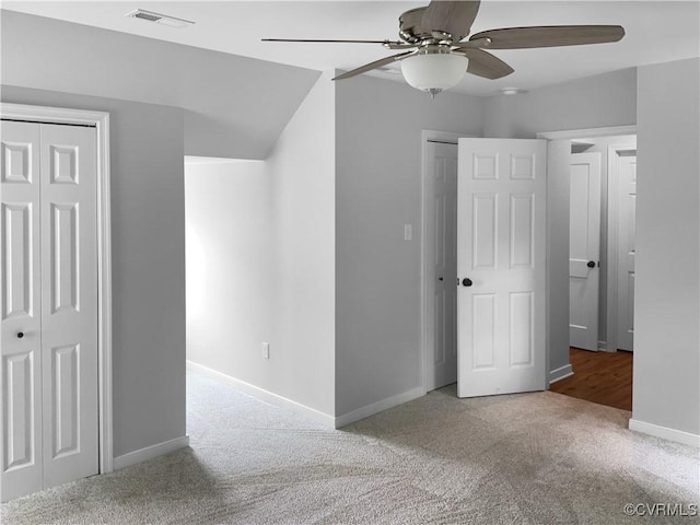 unfurnished bedroom with visible vents, carpet flooring, baseboards, and ceiling fan