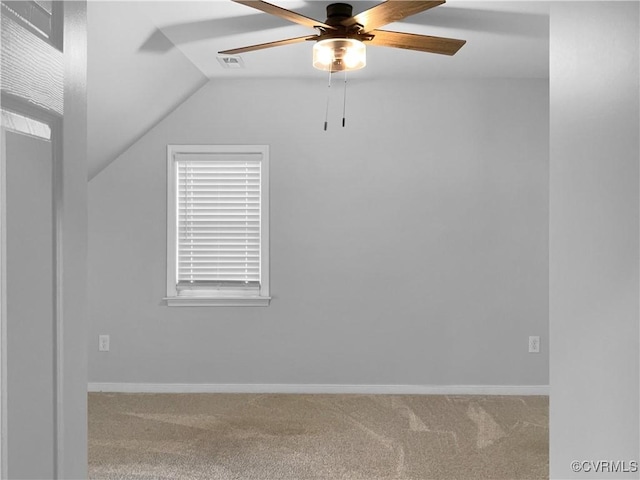 unfurnished room featuring visible vents, carpet, a ceiling fan, baseboards, and vaulted ceiling