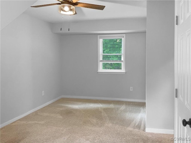 empty room featuring baseboards, a ceiling fan, and carpet
