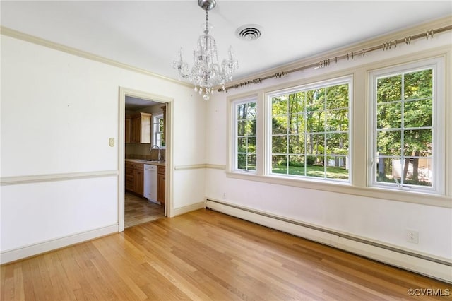 unfurnished dining area with an inviting chandelier, a sink, baseboard heating, light wood-style flooring, and baseboards