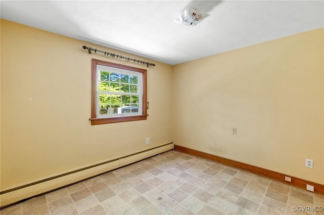 spare room with baseboards and a baseboard heating unit
