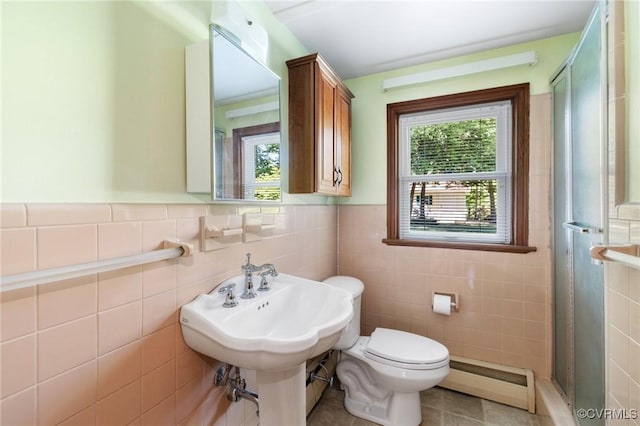 full bath featuring a stall shower, tile walls, a wealth of natural light, and a baseboard radiator
