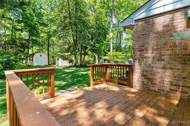 wooden terrace featuring a yard, an outdoor structure, and a storage unit