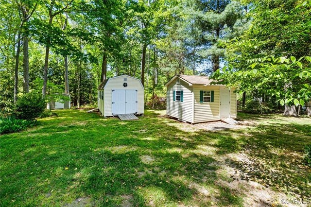 view of yard featuring a storage unit and an outbuilding