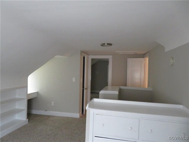interior space with baseboards and light colored carpet