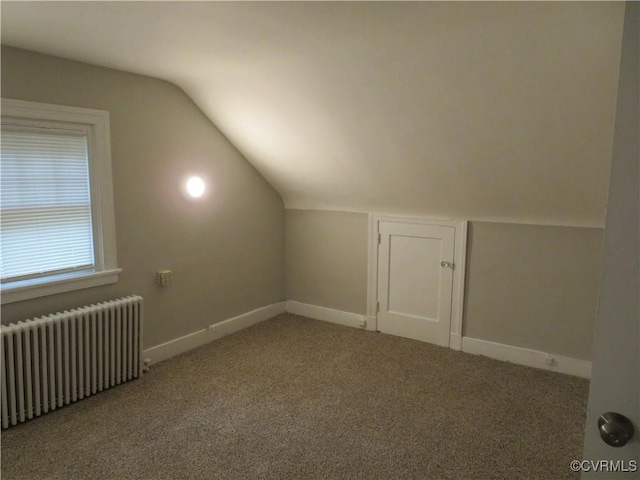 bonus room with baseboards, carpet, radiator, and lofted ceiling