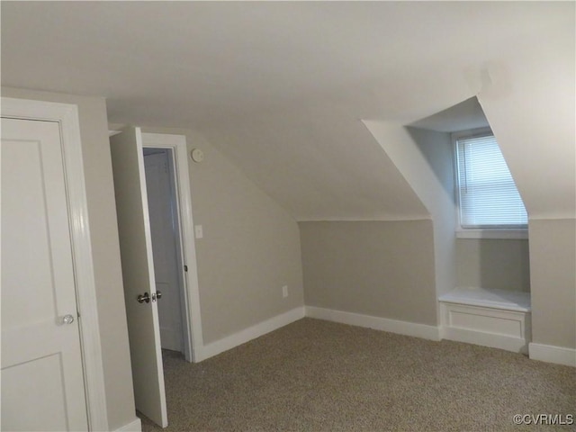 bonus room with baseboards, light carpet, and lofted ceiling