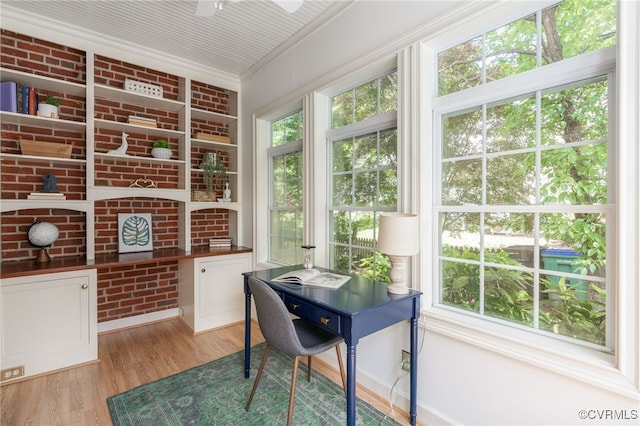 office space featuring ornamental molding, light wood-type flooring, and ceiling fan