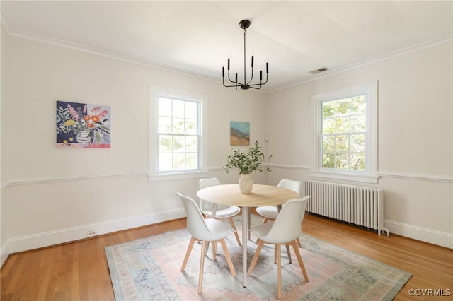 dining area with visible vents, radiator heating unit, a notable chandelier, and a healthy amount of sunlight