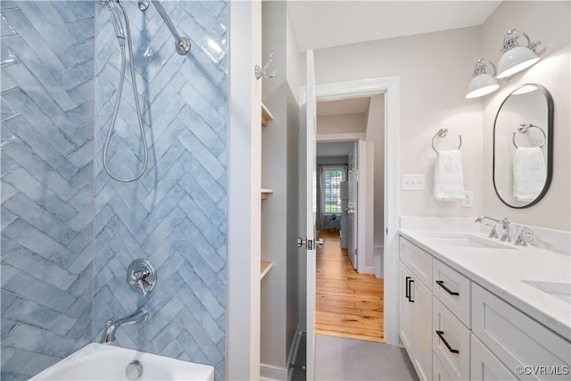 full bathroom with double vanity, shower / bath combination, and a sink