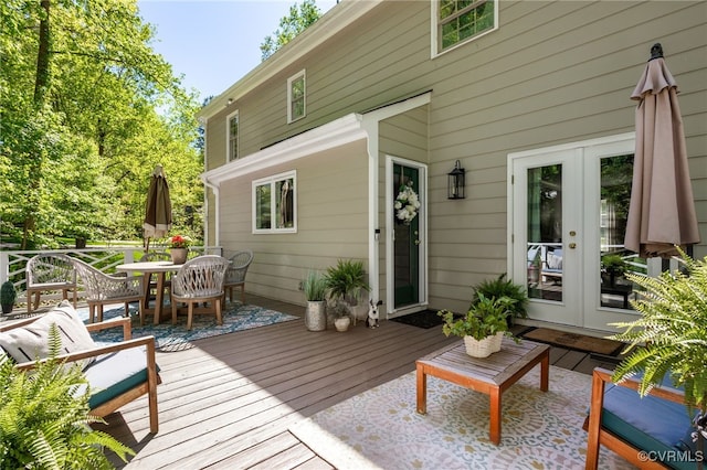 wooden terrace with french doors and outdoor dining space