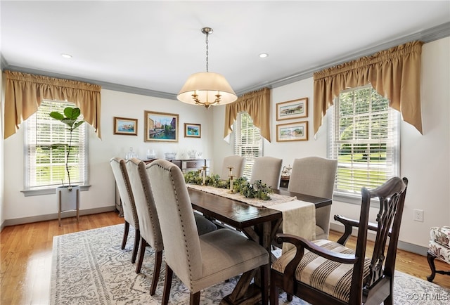 dining room with crown molding, baseboards, and plenty of natural light