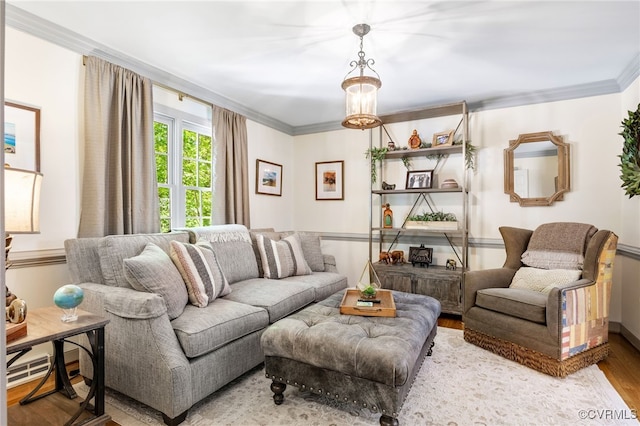 living room with ornamental molding and wood finished floors