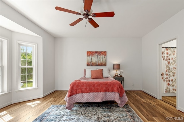 bedroom featuring a ceiling fan, baseboards, and hardwood / wood-style floors