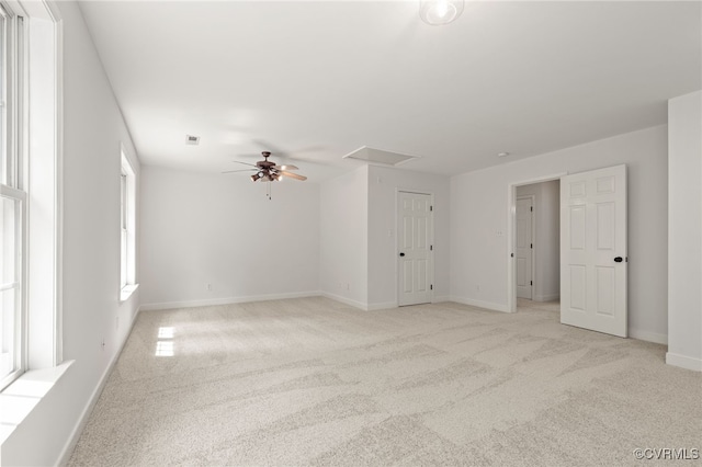 unfurnished room featuring baseboards, a ceiling fan, visible vents, and light carpet
