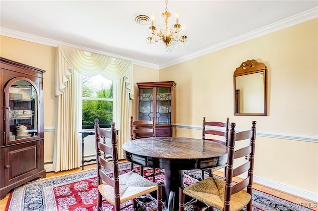 dining area with an inviting chandelier, light wood finished floors, crown molding, and visible vents