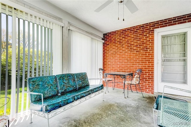 sunroom / solarium featuring an outdoor living space, a ceiling fan, and a wealth of natural light