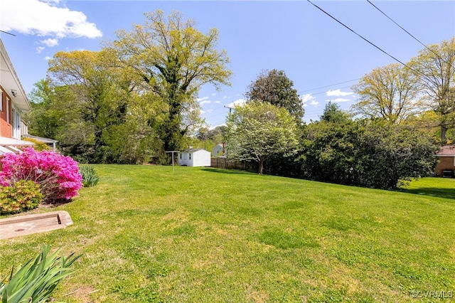 view of yard with a storage shed and an outdoor structure