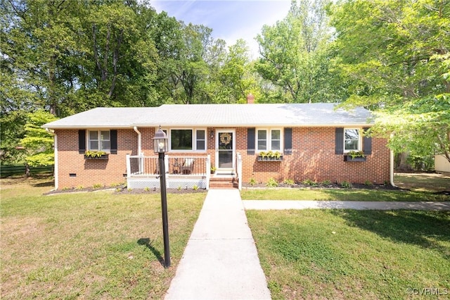 ranch-style home featuring brick siding and a front lawn