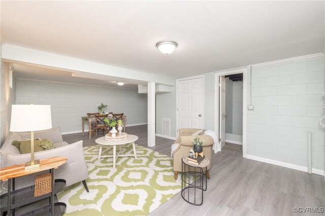 living room with baseboards, wood finished floors, and visible vents