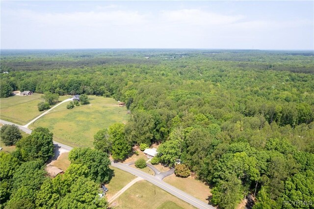 drone / aerial view featuring a wooded view