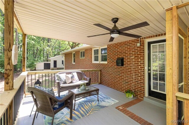 view of patio / terrace with a wooden deck, ceiling fan, and outdoor lounge area
