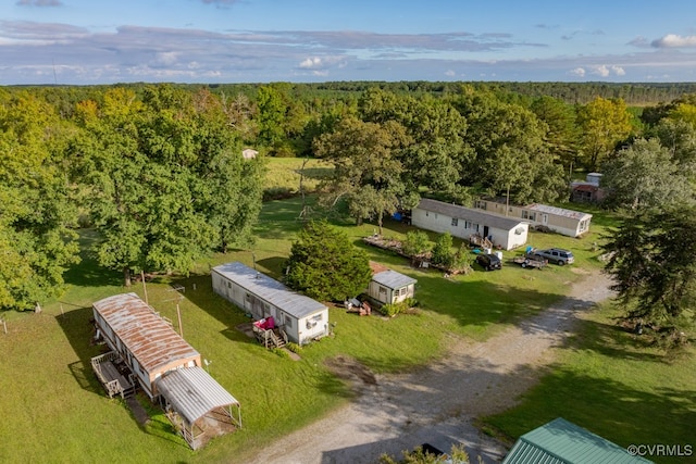 birds eye view of property featuring a wooded view