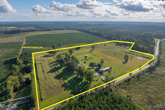 birds eye view of property featuring a view of trees and a rural view