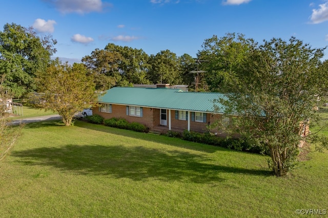 ranch-style house with a front yard and brick siding