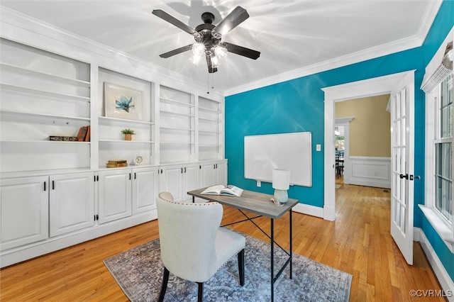 office area featuring built in shelves, ceiling fan, ornamental molding, and light wood-style flooring
