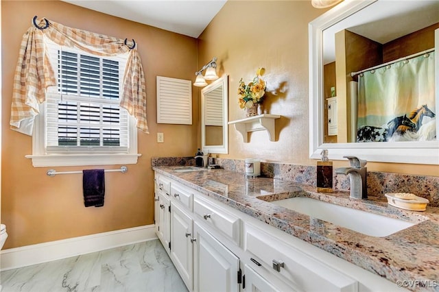 bathroom featuring a sink, toilet, double vanity, and marble finish floor