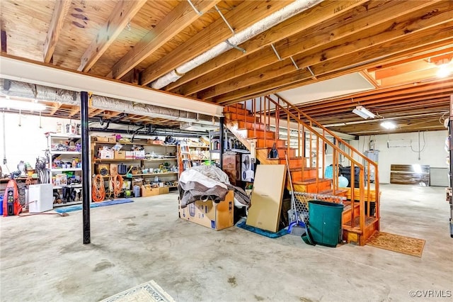 unfinished basement featuring water heater and stairs