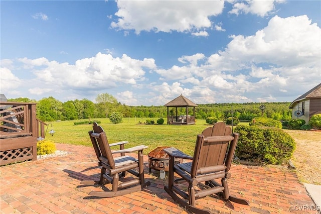 view of patio featuring a gazebo and a fire pit