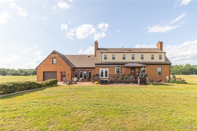 rear view of house featuring a gazebo, a garage, french doors, and a chimney